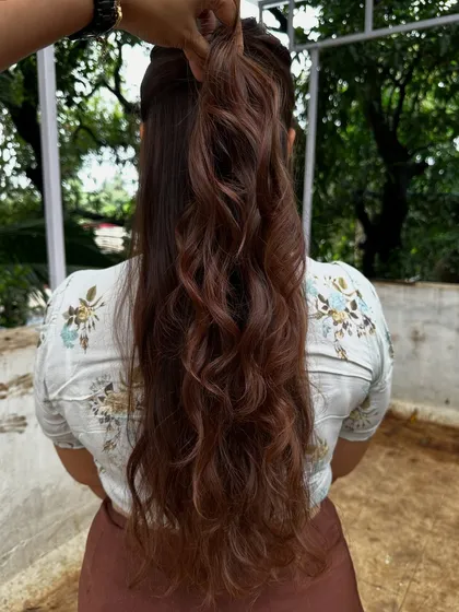 Getting ready for 'Ghar ki shaadi' (a home wedding). This client wanted a glamorous but natural look, so I gave her a rich color melt with soft waves, perfect for the occasion.
