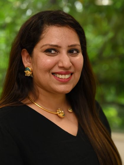 A client trying on a modern, sculptural necklace. Our private viewings are a celebration of artistry, where timeless heritage meets contemporary design.