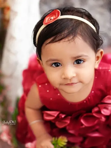 A close-up of this beautiful girl in her red floral dress. Sometimes a simple, direct look into the camera captures the most heart-melting portrait.
