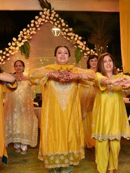 A beautiful synchronized pose from the ladies' mehendi performance.
