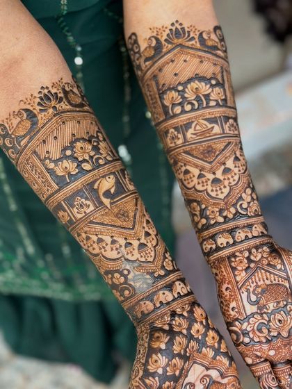 A detailed shot of the arm, highlighting the fish and lotus motifs.