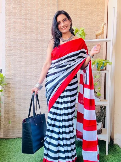 A bold and graphic saree with black, white, and red stripes. This is a very modern and chic design, perfect for making a style statement.