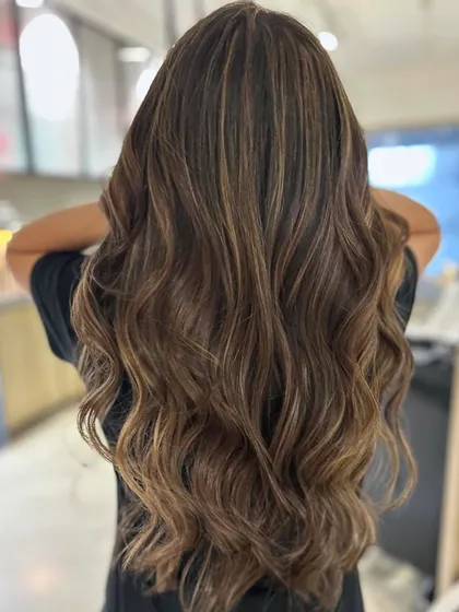 A stunning hair transformation using a three-tone blended highlight technique. The result is healthy, dimensional, and meets all the hair color goals.