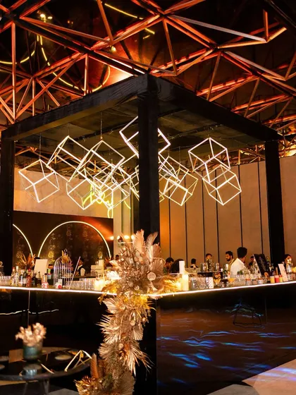 We transform spaces with dramatic lighting and bold structures. For this sangeet, we designed a central bar with a custom installation of illuminated geometric cubes, creating a high-energy focal point that was both a functional bar and a piece of modern art.