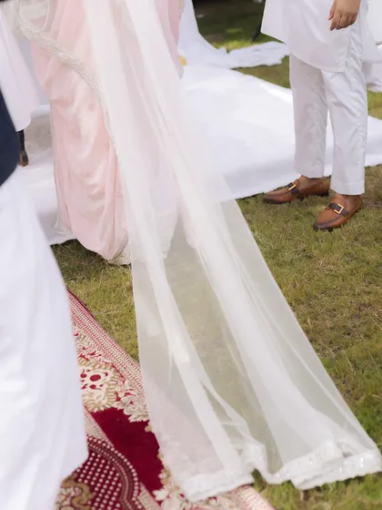 A detail shot of the bride's long, elegant veil as she walks during her Nikaah ceremony. This photo highlights the beauty and grace of traditional bridal attire.