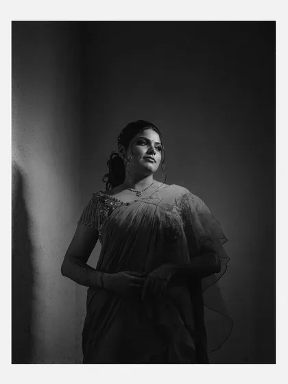 Another example of a classic black and white portrait, this image uses a single light source to sculpt the bride's features. The result is a powerful and elegant photograph that focuses purely on her form and expression.