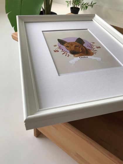 A different perspective of the framed Chiku portrait, highlighting the clean lines of the white frame and the professional matting.