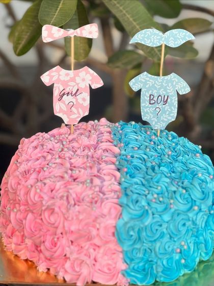 He or she? What will it be? This half-and-half gender reveal cake is a fun and delicious way to share your big news, with pink and blue rosette piping keeping the secret until the first slice.