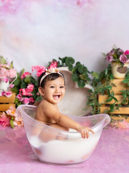 A big, beautiful smile from this happy baby in her pink floral bath. The joy on her face is what makes these splash sessions so rewarding to photograph.