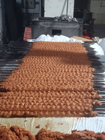 A massive batch of Chicken Sheek Kebabs ready for the grill. This shows the scale of preparation for a large wedding or corporate event order.