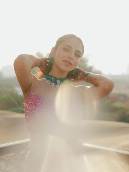 A sun-flared portrait of the bride, her face bathed in a warm, golden glow. This dreamy and ethereal shot captures her beauty in a soft and artistic way.