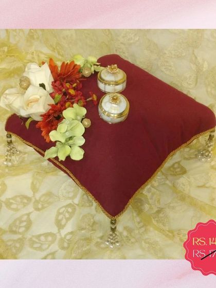 This classic maroon ring pillow is currently on sale. It's a simple, elegant, and affordable option for your ring ceremony, complete with small decorative boxes for the rings.