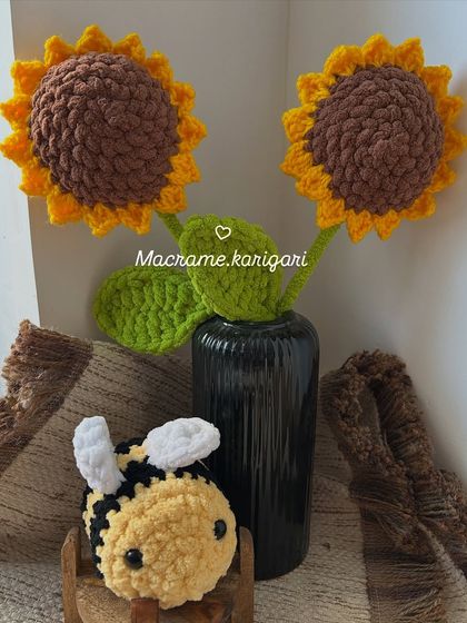 A pair of our biggest chunky yarn sunflowers yet, accompanied by a cute little crochet bumblebee. This combination creates a playful and charming nature-inspired scene.