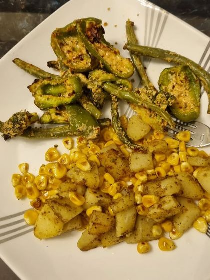 Another simple and delicious vegetarian meal. This plate has air-fried capsicum and green beans with a side of spiced potatoes and corn. Using an air fryer is a great way to get that roasted texture with minimal oil.