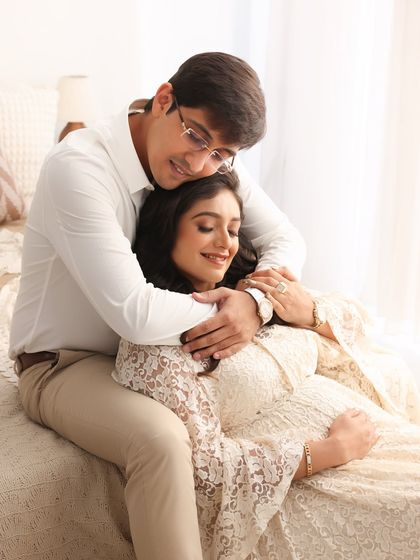 A sweet and tender moment. The gentle way he embraces her from behind shows his love and protection as they cherish this special time.