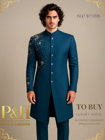 A closer look at the peacock blue suit, detailing the scattered hand-embroidery that mimics a starry night, offering a unique and captivating design.