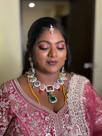 A close-up of the regal glam look we created for a reception in Pondicherry. The soft berry pink shimmer on the lids, paired with smokey outer corners, creates beautiful depth.