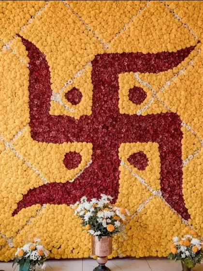 I can create custom floral mosaics like this beautiful Swastika, a powerful and auspicious backdrop for your religious ceremonies and festivals.