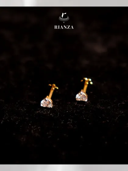 A closer look at our classic solitaire diamond studs against a dark background. Their simplicity is their strength, making them a versatile accessory for any occasion.