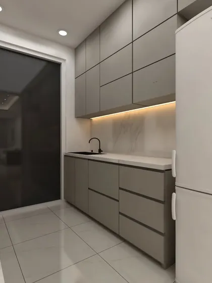 This kitchen view highlights the seamless, handleless cabinetry and dark countertop. The layout ensures all essentials are within easy reach, making cooking a breeze.