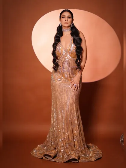 Another angle of the full-length gown, showing how it catches the light. The styling is all about confidence and making a statement.