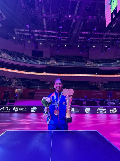 Divyanshi, beaming with pride, holding her trophy and medals after her historic win at the Asian Youth Championship in Tashkent. A testament to her hard work and our academy's high-performance training.