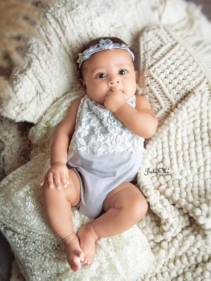 A sweet and thoughtful expression from this little one. The neutral tones and soft textures create a calm and timeless portrait.