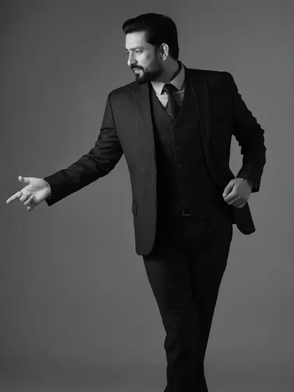 A dynamic pose from Aadesh Chaudhary in a suit. Movement adds energy to a still photograph, making it more engaging.