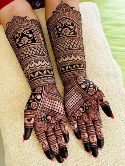 Personalize your bridal mehndi with your and your partner's names. In this design, I have woven the letters of their names into the fingertips, adding a unique and modern touch to a traditional pattern.