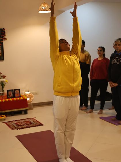 The raised arms pose, or Hasta Uttanasana, is a gentle backbend that opens the chest and energizes the body at the start of the sequence.