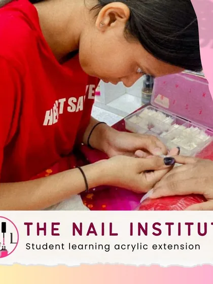 This student is learning the fundamentals of acrylic extensions, from picking up the bead to patting it into place.