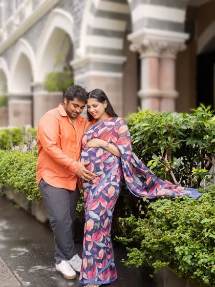 This portrait captures a quiet, tender moment between the couple against a classic architectural backdrop in Mumbai. It's a beautiful blend of urban scenery and personal connection.