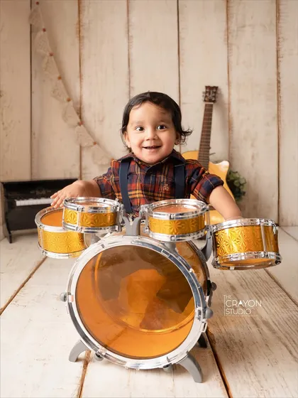 As babies grow, their personalities shine. This little rockstar session is all about capturing that playful spirit with fun themes that reflect their budding character, from tiny drummers to future explorers.
