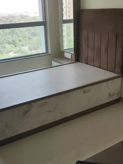 A single bed with a vertically-tufted brown velvet headboard. This piece also includes a storage base, making it a great solution for smaller rooms.