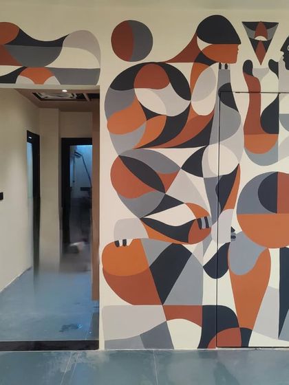 A geometric mural with abstract human figures, wrapping around a doorway and integrating into the architecture of the space.
