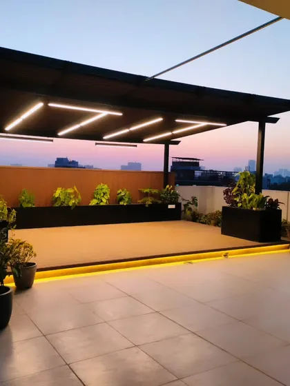A modern pergola at sunset in Palam Vihar, Gurgaon. The clean lines and integrated lighting create a sleek, contemporary look.