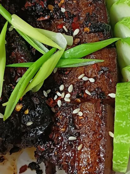 Another angle of the spicy glazed pork, showing the char and the fresh garnish. This is one of my popular ready-to-eat dry pork preparations.