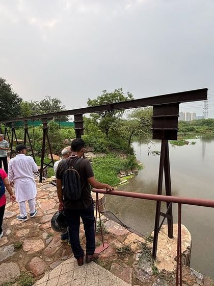 Visitors on our community walk cross a bridge over the serene jheel at Ghata Bundh, a site that now feels a world away from the concrete jungle of Gurgaon.