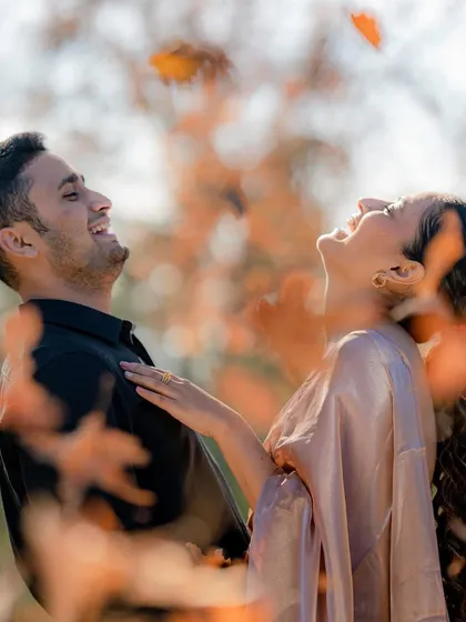A candid moment of pure joy as a couple shares a laugh, surrounded by the warm, soft light of an autumn forest. This is the kind of unposed, genuine emotion I love to capture in my lifestyle portrait sessions.