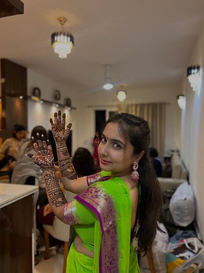 A candid shot of the bride during her mehendi application, showing the relaxed and happy atmosphere I create.