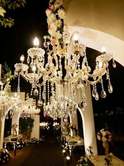 A close-up of the stunning crystal chandeliers, showing their intricate detail and the beautiful light they cast.