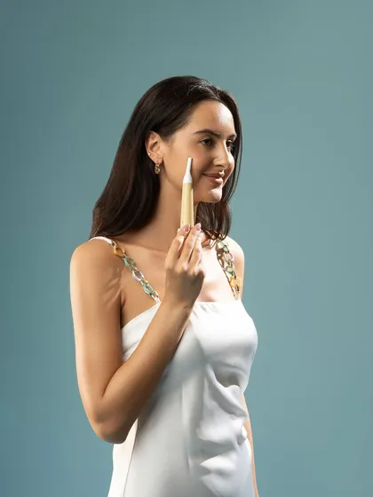 A profile shot of a model using a facial grooming tool. This image focuses on the product's application and the user's positive experience, highlighting ease of use and gentle effectiveness.
