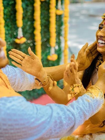 A playful and candid moment between a couple during their Haldi ceremony. We love capturing the fun and games that are part of the celebration.