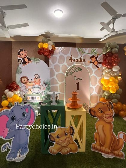 Another view of our jungle safari setup, showcasing the arrangement of character cutouts, themed pedestals for the cake, and personalized backdrops.