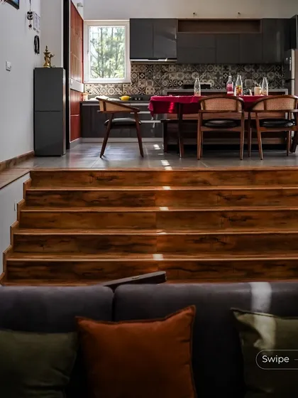 The open-plan living and dining area, showing the visual connection between the different levels and the overall sense of spaciousness.