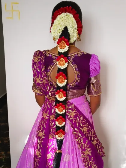 A traditional South Indian bridal hairstyle, or *Jadai*, is my specialty. I love creating these intricate braids, weaving in fresh jasmine and other flowers for a classic and beautiful look.