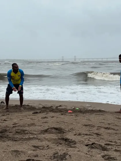 A coach demonstrates the ready position during a beach fielding drill. We train our players to always be alert and prepared for any opportunity in the field.