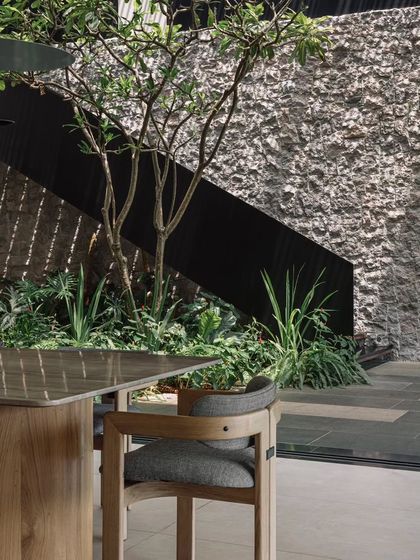 A detail of the dining area, showing how it overlooks the central courtyard. The design ensures that even indoor spaces feel connected to the home's natural heart.