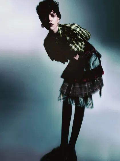 An image using motion and blur to create a feeling of movement and energy. The focus is on the overall shape and feeling of the outfit rather than sharp details.