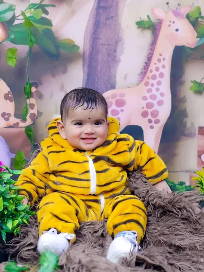 A smiling baby tiger in our jungle-themed set. The costumes are comfortable and perfect for cute photos.
